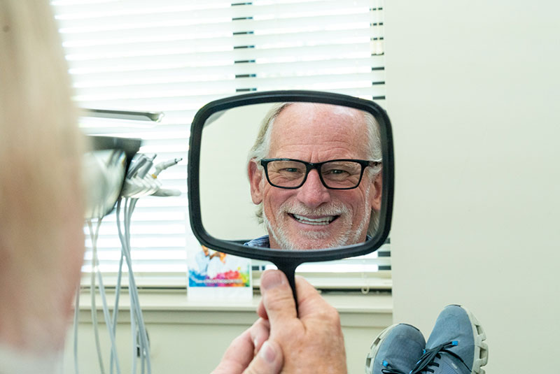 Patient holding up mirror